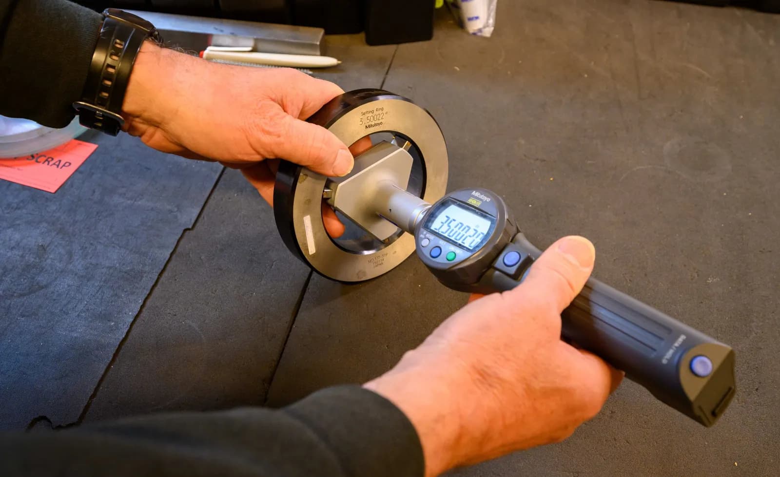 An inspector checks a bore with a digital gauge